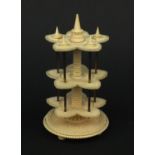 Georgian turned and carved ivory three tier cotton reel stand, 17.5cm high