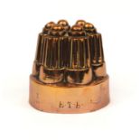 Victorian copper jelly mould, initialled E.T.B. numbered 476 and partial marks to the rim, 11.5cm
