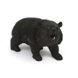 Carved wooden bear with beaded eyes and bone teeth, 24.5cm in length