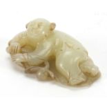 Chinese pale jade carving of a young boy upon a lily pad, 7cm wide