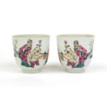 Pair of Chinese porcelain tea cups, hand painted in the famille rose palette with court figures