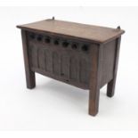 Antique oak plank coffer of small proportions with hinged lid, the front panel with gothic arches,