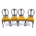 Set of four carved mahogany dining chairs with gold upholstered stuff over seats. Each 96cm high