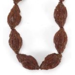 Chinese carved coquilla nut bracelet, the nuts each carved with figures, each nut approximately 3.