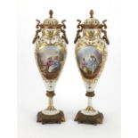 Pair of 19th century Sevres urns and covers, hand painted and gilded with flowers and figures,