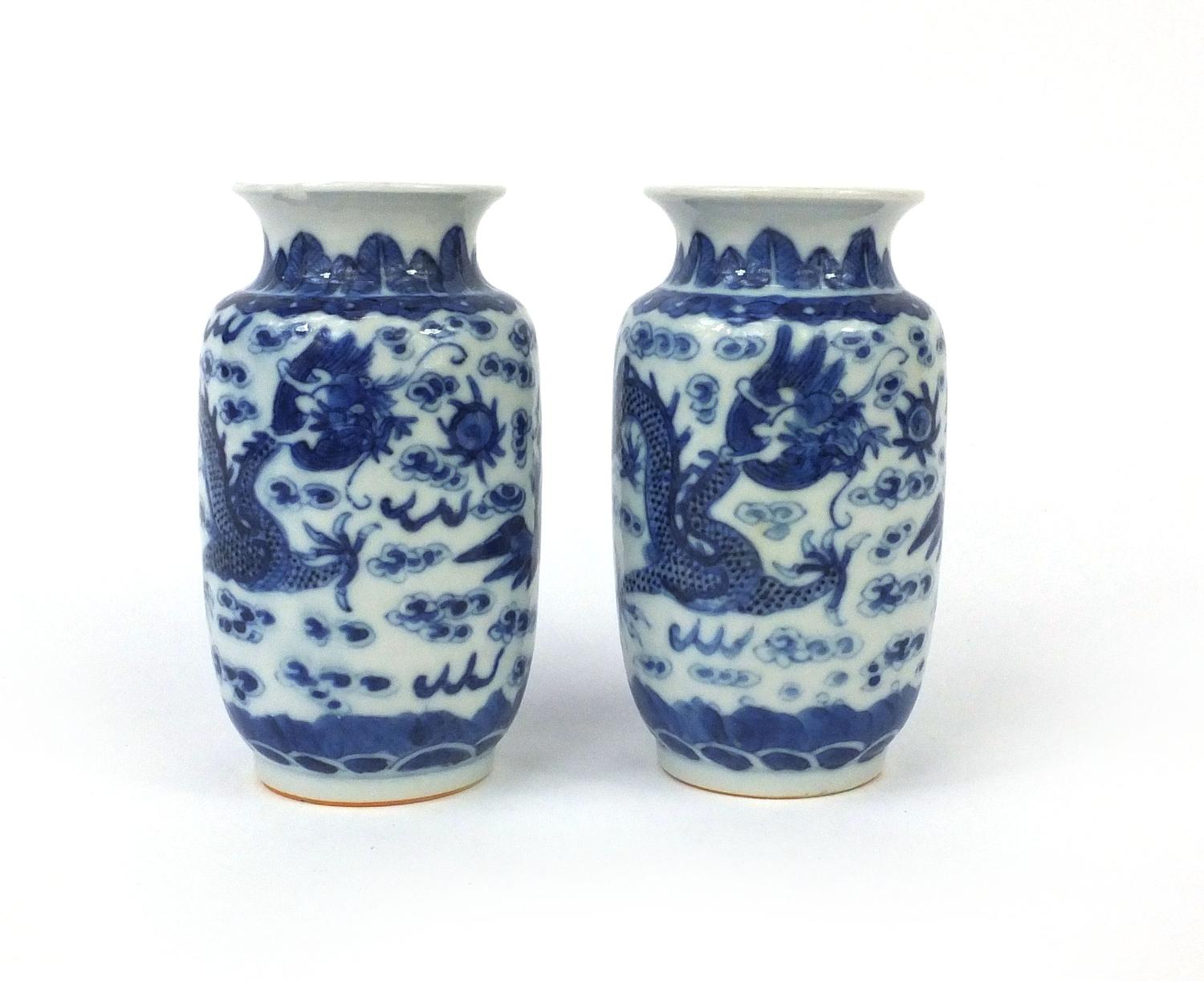 Pair of Chinese blue and white porcelain vases, both hand painted with phoenixes and dragons chasing