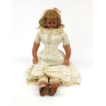 19th century wax headed doll with wax limbs wearing a lace dress and leather shoes, overall 63cm