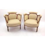 Pair of Edwardian inlaid rosewood tub chairs with panel upholstered backs and upholstered stuff over