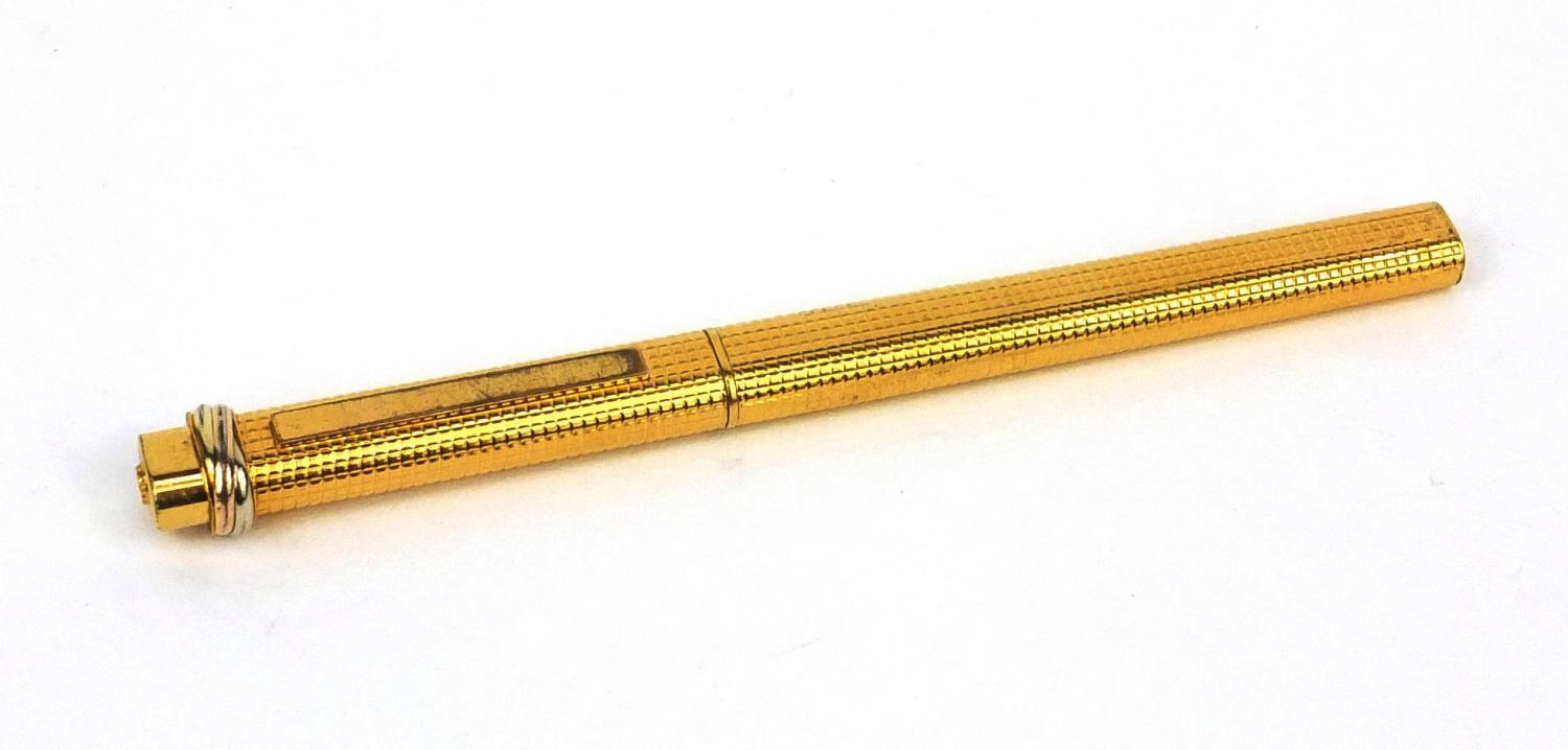 Cartier gold plated ballpoint pen with engine turned decoration, numbered 2298301