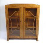 Art Deco walnut china cabinet fitted with a pair of glazed doors enclosing two shelves, 124cm high x