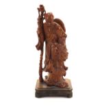 Chinese root carving of an elder holding a double gourd vessel and a staff, raised on a