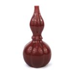 Chinese porcelain Sang De Boeuf glazed vase, of naturalistic double gourd form, six figure