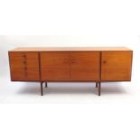 1970's teak sideboard fitted with three cupboard doors and four graduated drawers, 77cm high x 199cm