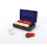 Part stained ivory draughts housed in a velvet lined fitted case, the case 14cm in diameter