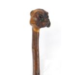 Wooden shillelagh carved with a bulldogs head set with beaded eyes, 62cm in length : For further