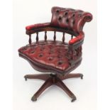 Mahogany framed ox blood leather button back captains chair with brass paw feet, 80cm high : For