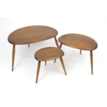 Ercol elm nest of three pebble tables, label to the inside of the larger, 40cm H : For further