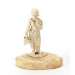 Ivory carving of a young female holding a vessel on a shaped ivory base, 8.5cm high : For further