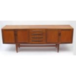 1970's G-plan teak sideboard fitted four drawers flanked by two pairs of cupboard doors, label to