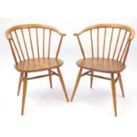 Pair of Ercol light elm stick back tub chairs, each with labels and 77cm high : For further