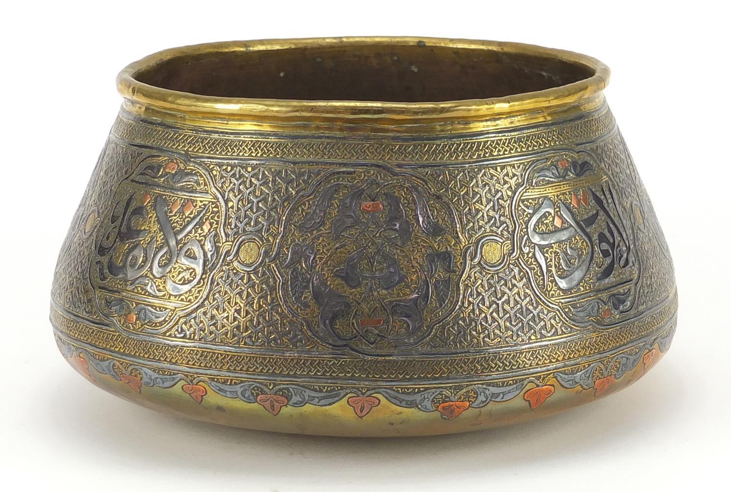 Cairoware brass bowl with silver inlay decorated with script and floral motifs, 25cm in diameter :
