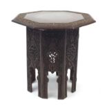 Middle Eastern octagonal table profusely carved and pierced with foliage, 50cm high x 49cm in