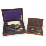 Victorian rosewood drawing instrument set with brass inlay together with an oak example, both