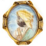 Oval hand painted portrait miniature of an Indian gentleman wearing a hat, housed in a gilt metal