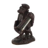 Black forest desk thermometer carved in the form of a dog holding a trombone, 13cm high : For