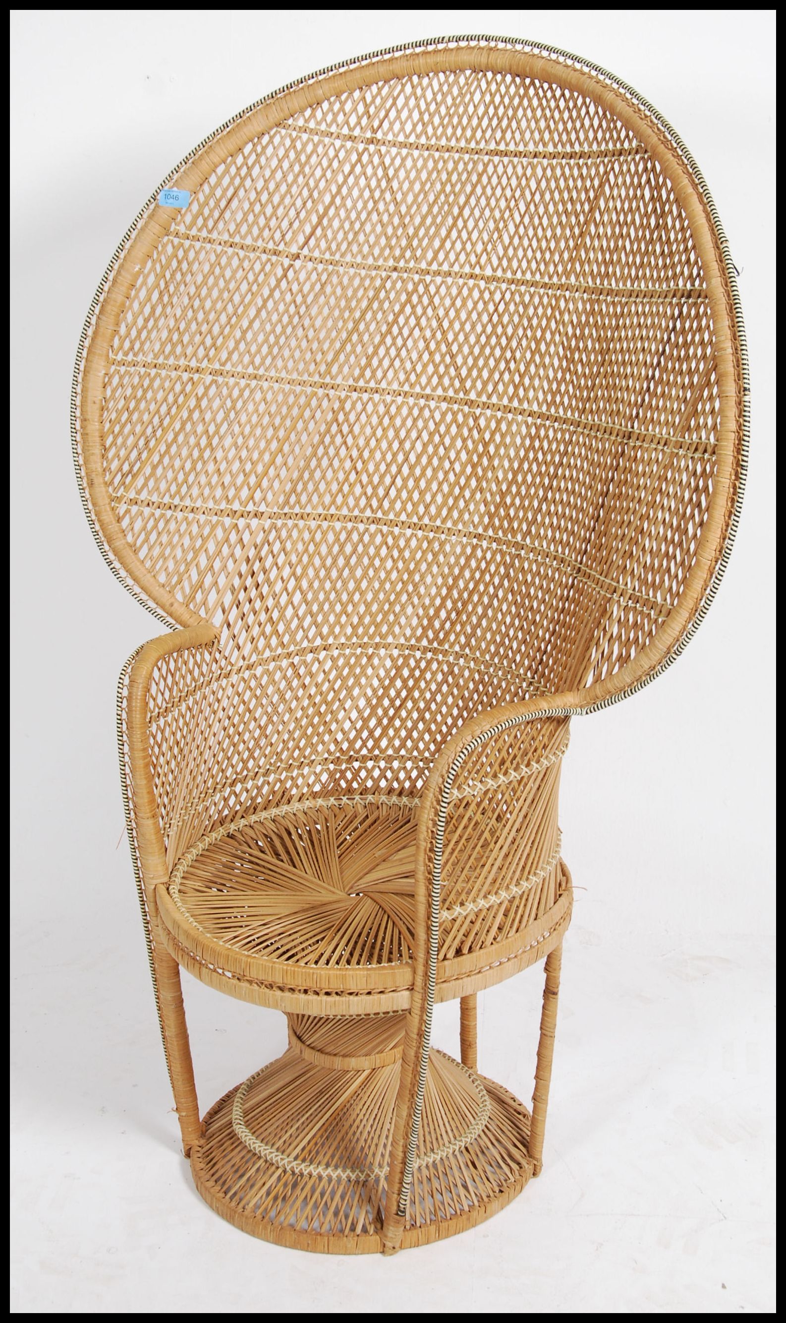 A vintage 20th century retro wicker peacock armchair with a large open back and woven seat. Measures - Image 2 of 5