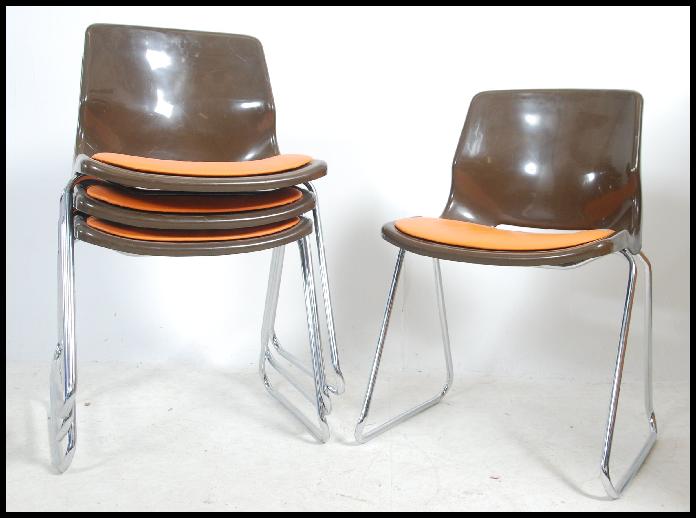 A set of 1970's retro stacking chairs in brown plastic having orange pad seats to the centre being - Image 3 of 4