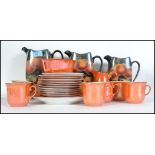 A vintage 20th century graduating set of three lustre jugs together with a lustre six person tea