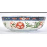 A 19th century Chinese Imari bowl with blue and white glaze having geometric pattern borders with