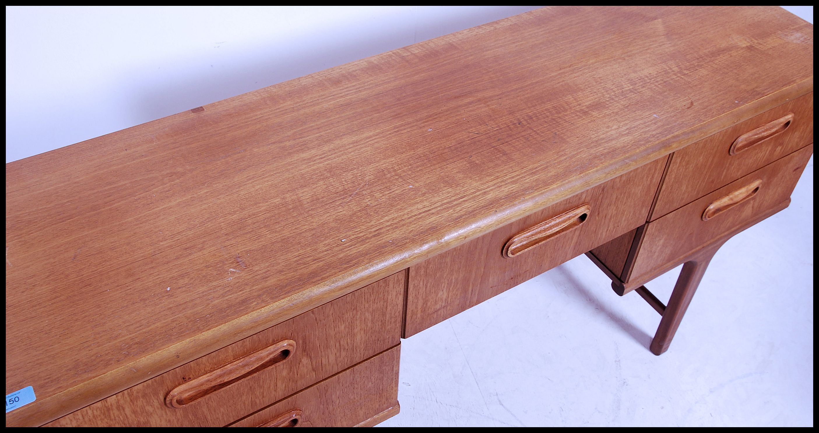 A 1970's Danish inspired retro teak wood writing table desk. The desk with central kneehole recess - Image 4 of 5