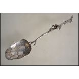 A Victorian silver ( tested )large berry spoon having twig handle adorned with flower head. The