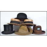 A collection of vintage gentleman's hats to include straw boaters, top hat, bowler, Australian