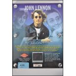 An original swatch of John Lennon's shirt - mounted in a sealed presentation display with integral