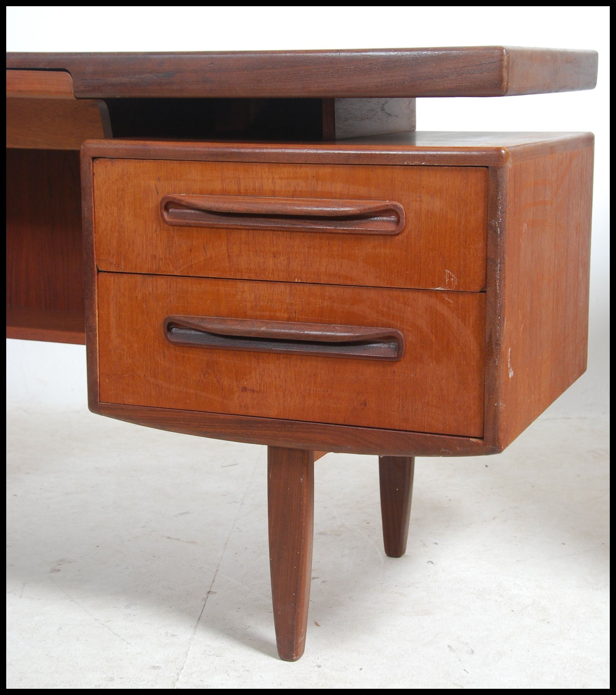 A 1970's G-Plan Fresco pattern teak wood writing table desk having a series of drawers with recessed - Image 3 of 3