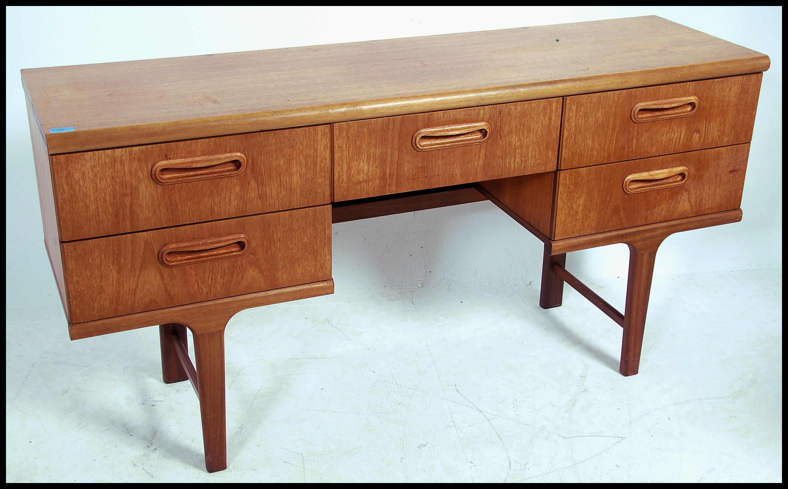 A 1970's Danish inspired retro teak wood writing table desk. The desk with central kneehole recess - Image 2 of 5