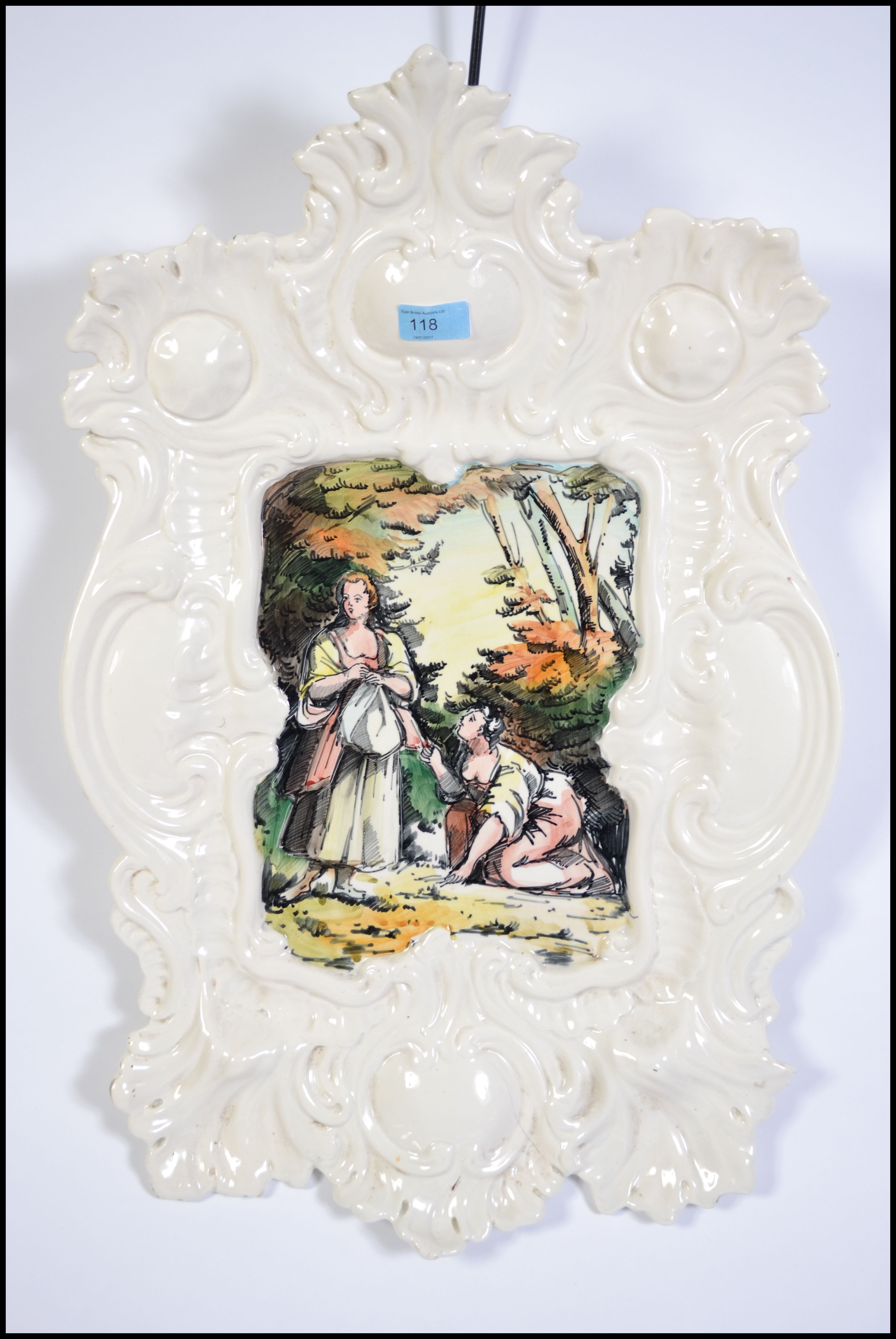 A large wall hanging ceramic wall charger. Italian in origin having a rococo stylized border with