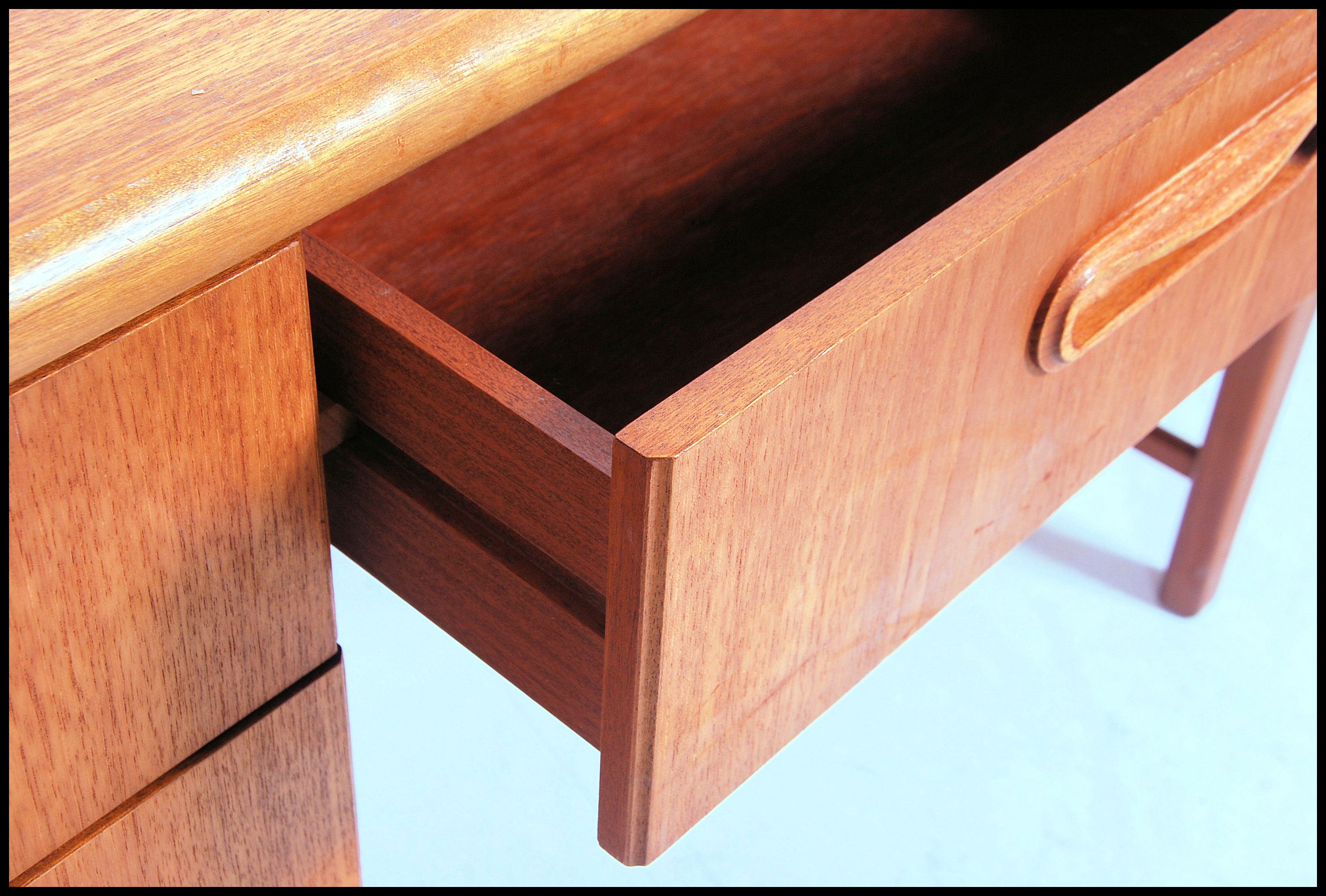 A 1970's Danish inspired retro teak wood writing table desk. The desk with central kneehole recess - Image 3 of 5