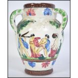 An unusual believed continental Italian faience three-handled vase painted with pastoral figures