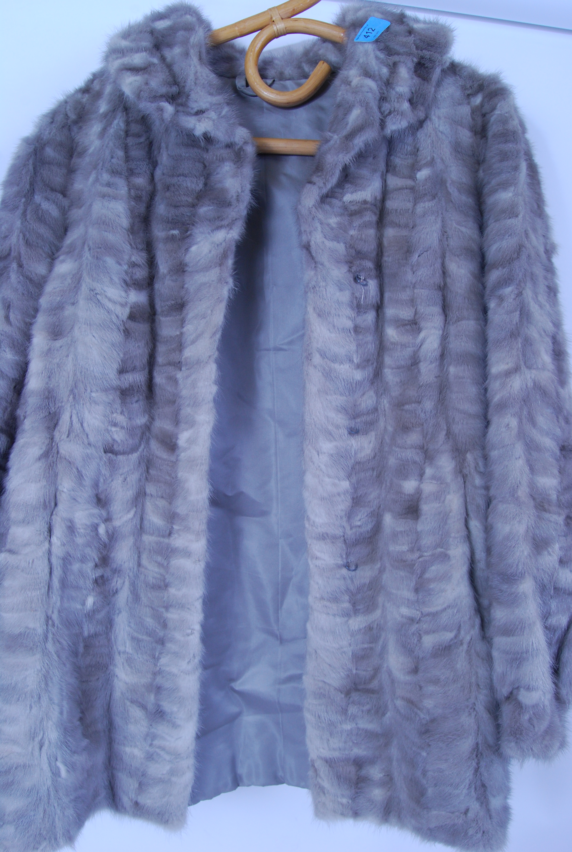 A vintage 20th century ladies hip length fur coat  in a soft grey colour.
