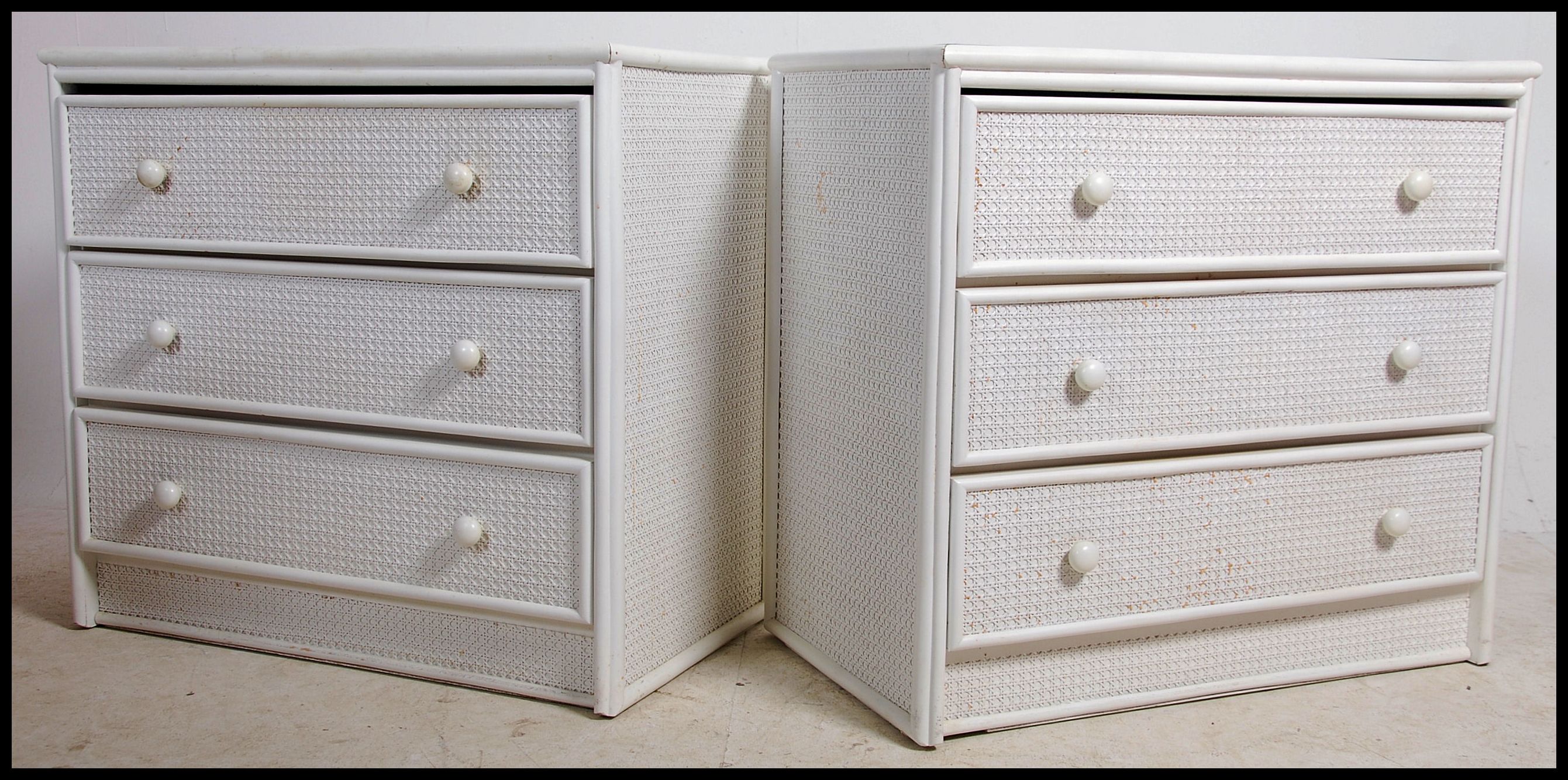 A pair of 20th century whicker effect chest of drawers. Each Chest of drawers having four long