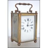 An early 20th century brass cased carriage clock having inset movement with carved lion motif. The