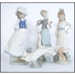 A collection of porcelain Lladro and Nao figurines to include a Lladro duck and 3 Nao figures to