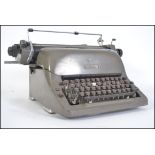 A vintage industrial 20th century typewriter by Adler having original grey finish.