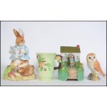 A collection of ceramics to include a Beswick eagle, Carlton Ware Art Deco beaker, Schmid musical