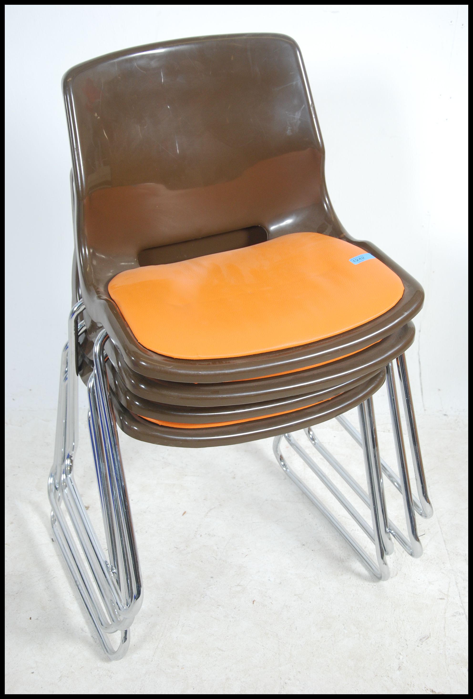 A set of 1970's retro stacking chairs in brown plastic having orange pad seats to the centre being - Image 2 of 4