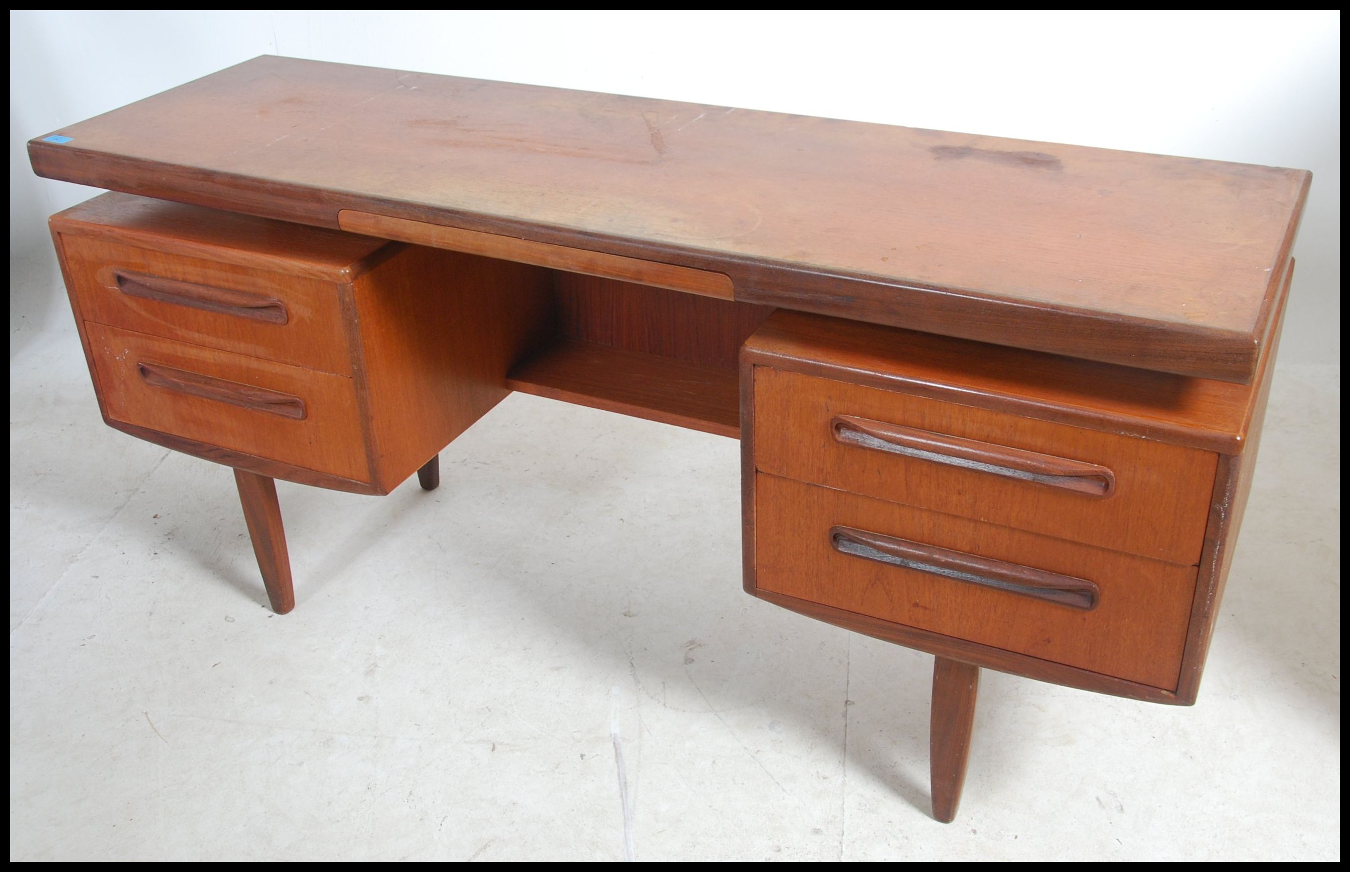 A 1970's G-Plan Fresco pattern teak wood writing table desk having a series of drawers with recessed - Image 2 of 3